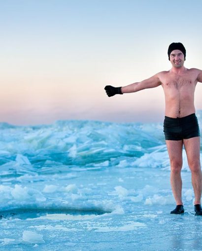 Man is going to swimm in an ice-hole on beautiful winter day