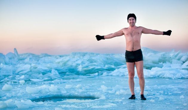 Man is going to swimm in an ice-hole on beautiful winter day